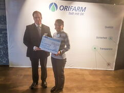 Ein Mann und eine Frau halten einen Scheck in der Hand